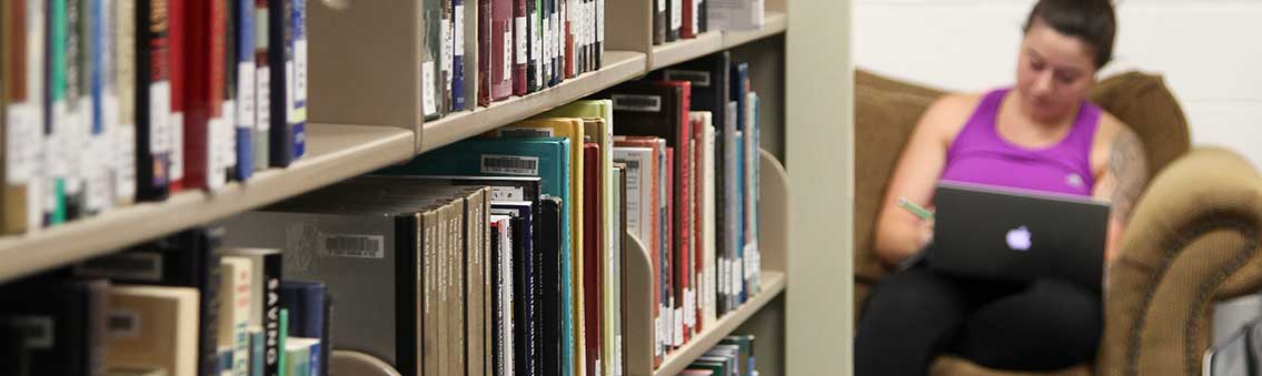 Thomas University student studying in the library